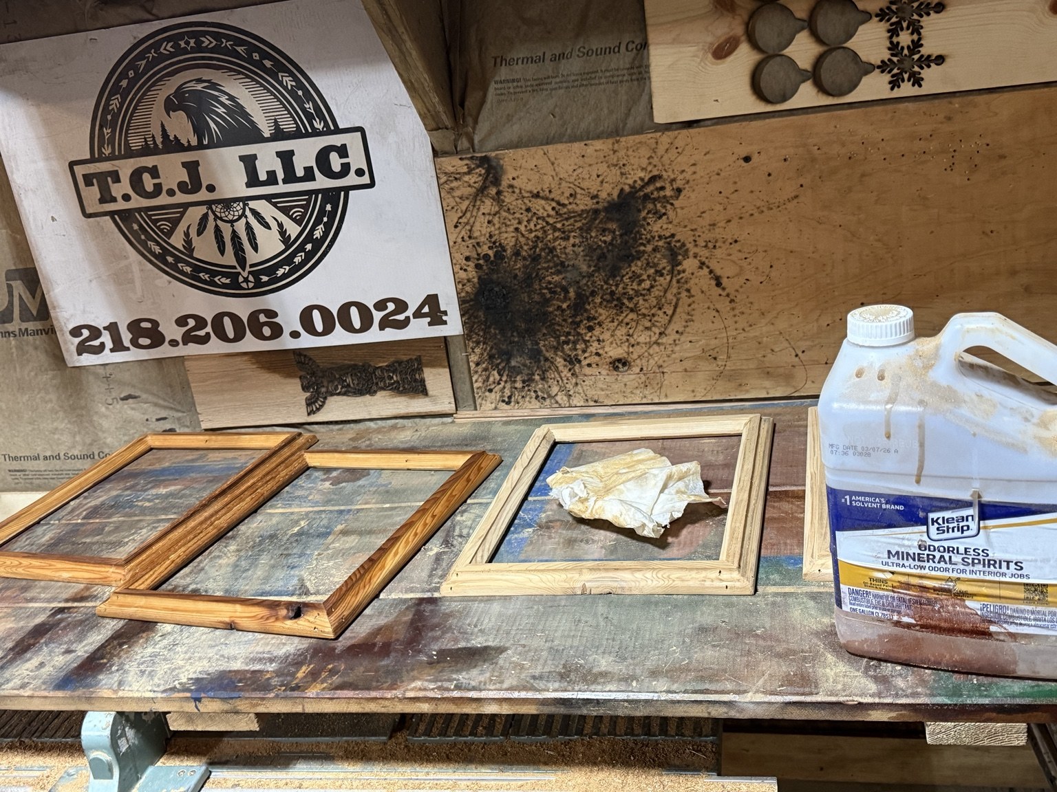 Wooden frames at different stages of cleaning and staining on Tim’s workshop bench