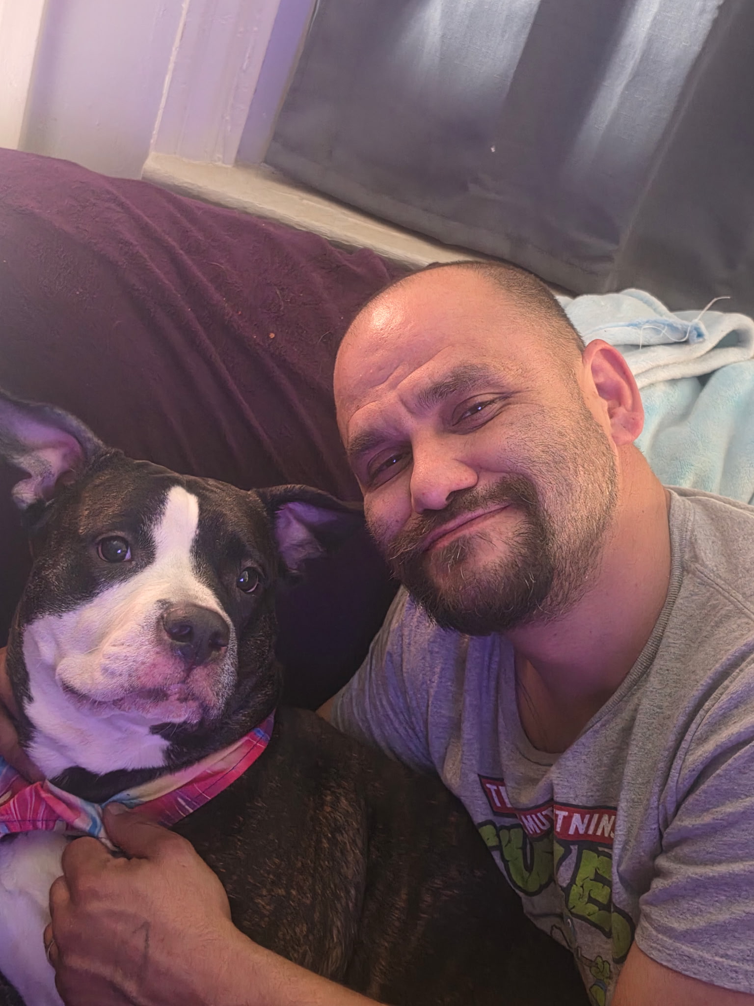 Tim Jordon relaxing at home with his dog